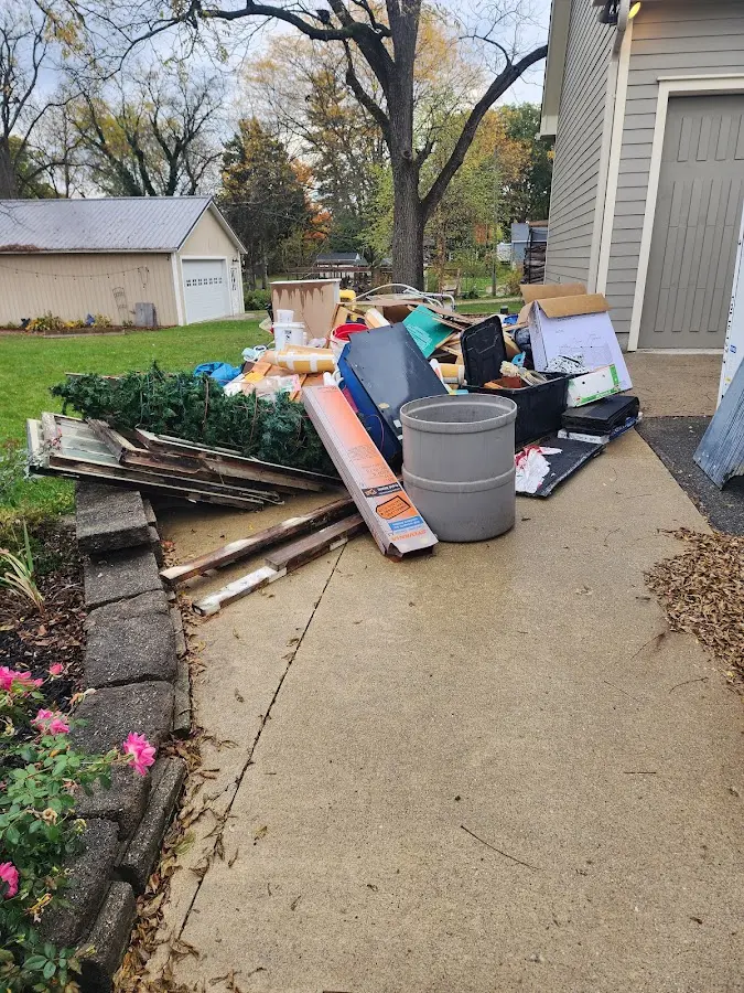 Dumpster being loaded with debris for 12 Yard Dumpster Rental in Mount Pleasant